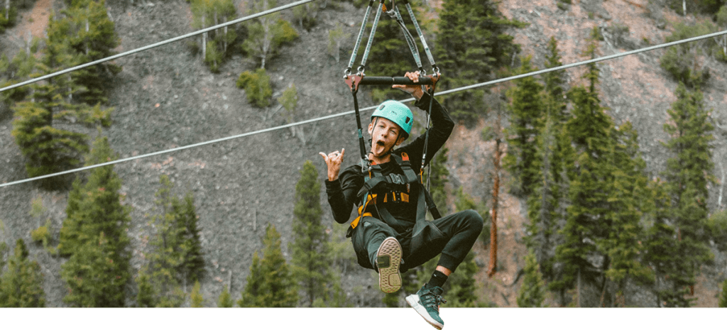 teen zip line over lake